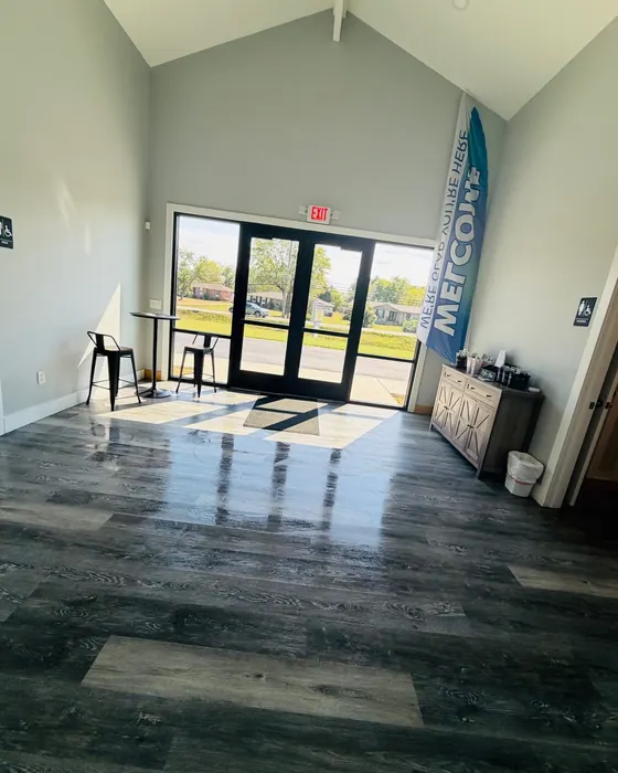 Church lobby with glass doors and freshly cleaned plank floors reflecting the light