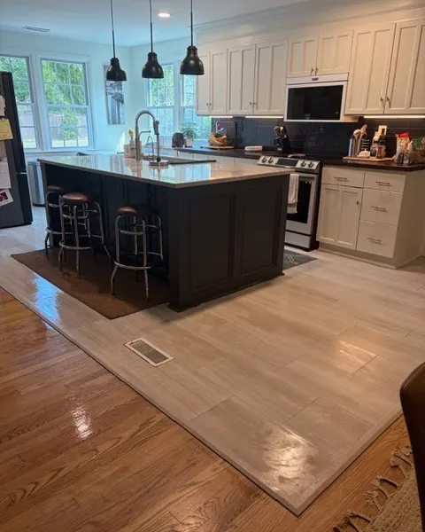 After: the same kitchen with the island cleared and the floors shining