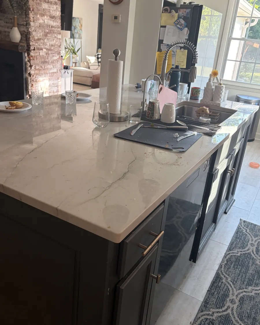 Before: a kitchen island counter covered with dishes, a drying mat and clutter