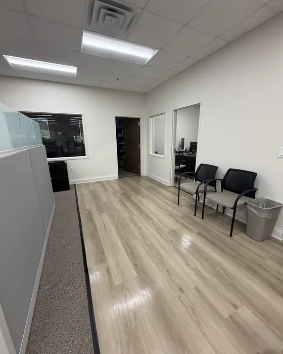 Office reception hallway with waiting chairs and polished floors